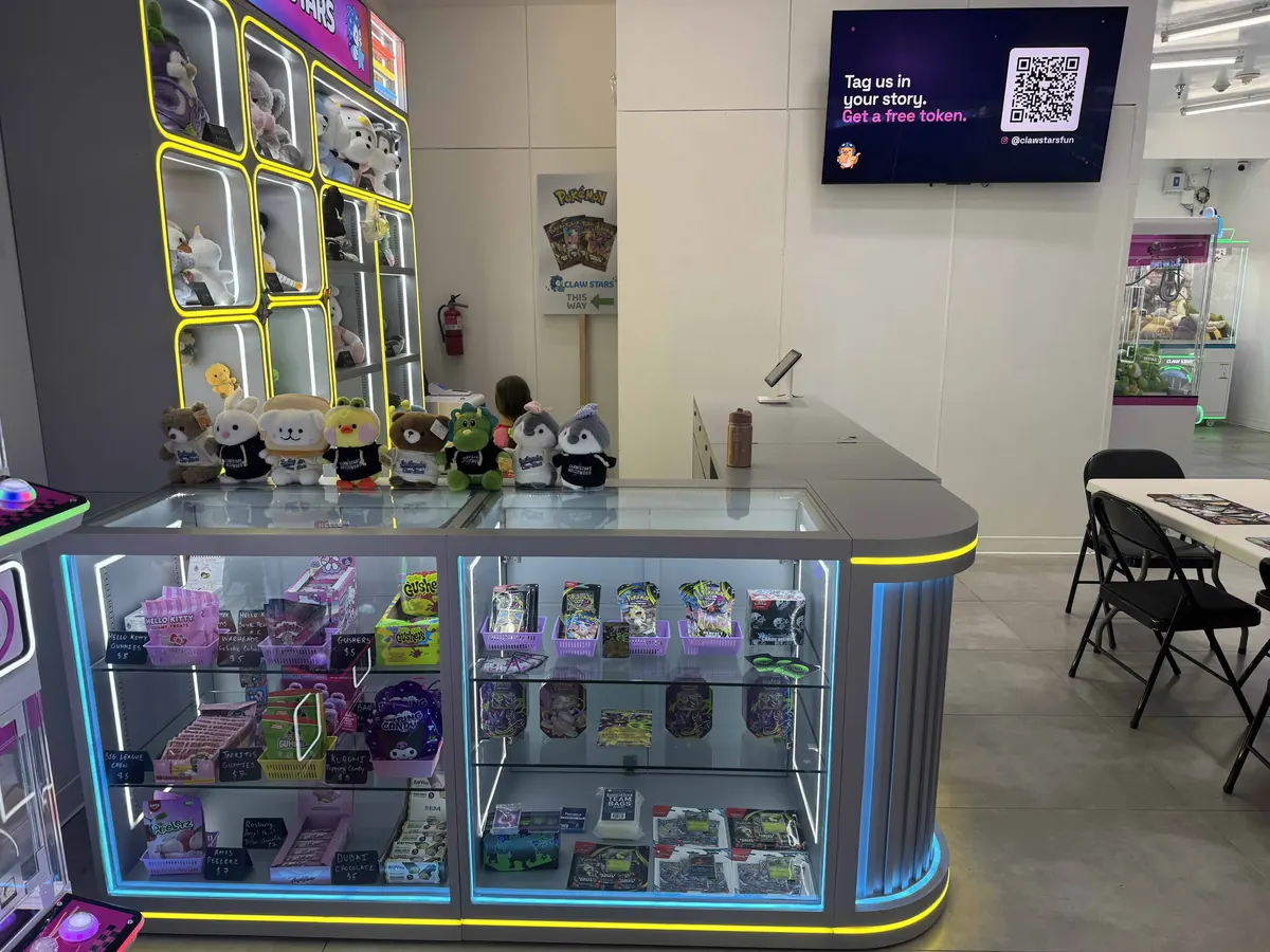 The Claw Stars front counter, prizes in a lit glass case